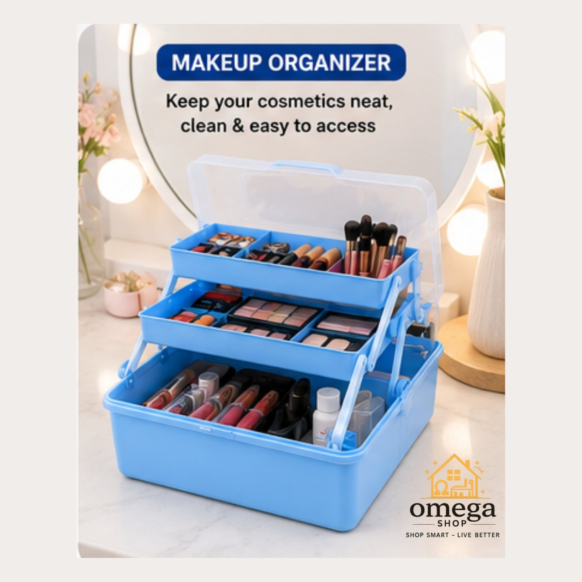 A blue three-tier makeup organizer with a clear lid, shown open and filled with cosmetics on a bathroom vanity. Text at the top reads 'MAKEUP ORGANIZER' and the Omega Shop logo appears at the bottom right.