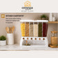 A white kitchen countertop grain dispenser with six clear vertical compartments filled with different dried grains and legumes, shown in a styled kitchen setting. The image includes a top logo for 'Omega Shop' and a text callout on the left describing the product's benefits.