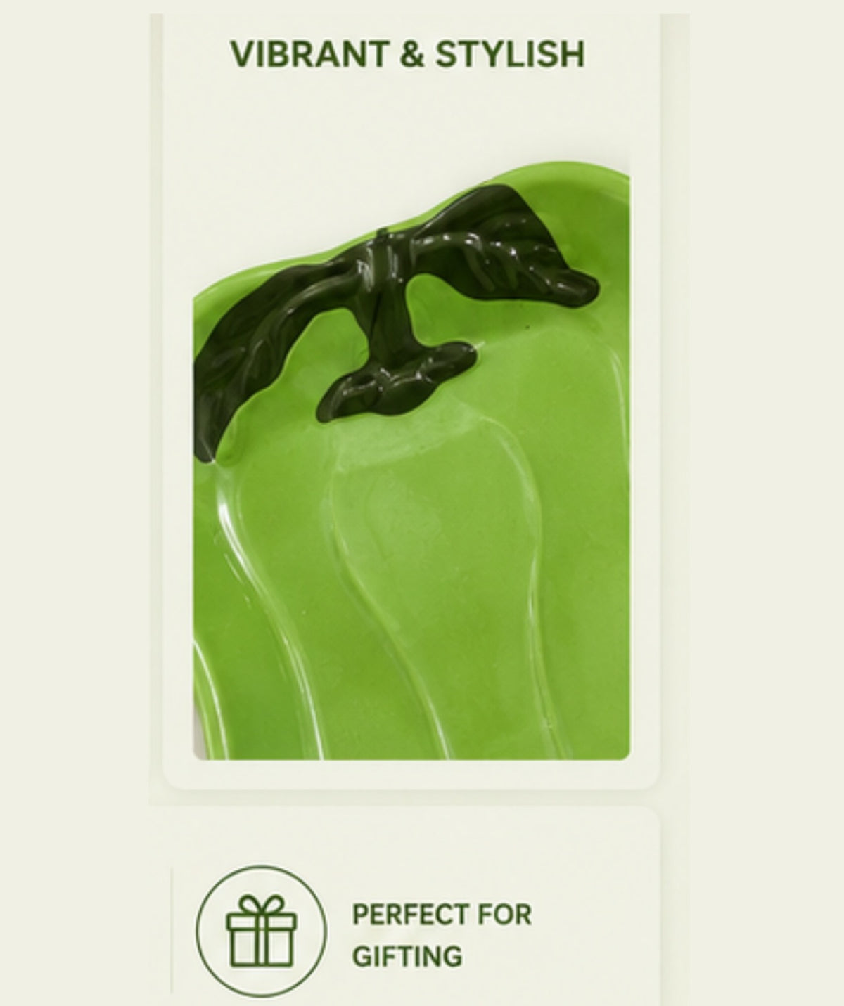 Green ceramic dish with a black handle on a white background