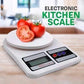Electronic kitchen scale with tomatoes on a wooden surface