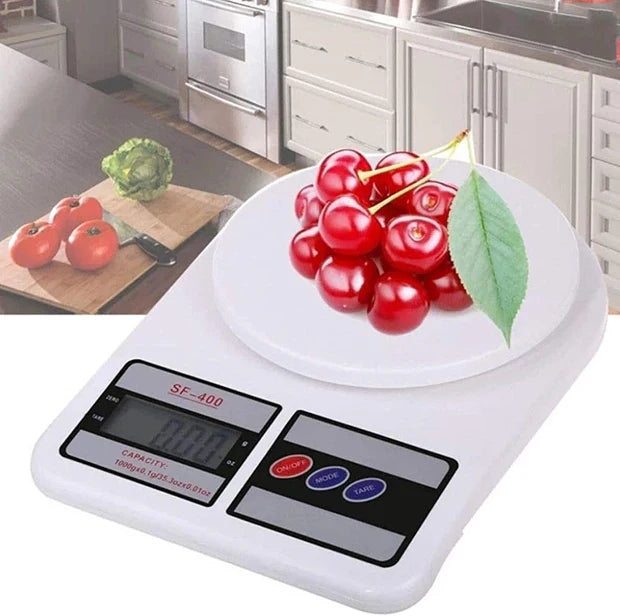 Digital kitchen scale with cherries on a kitchen counter